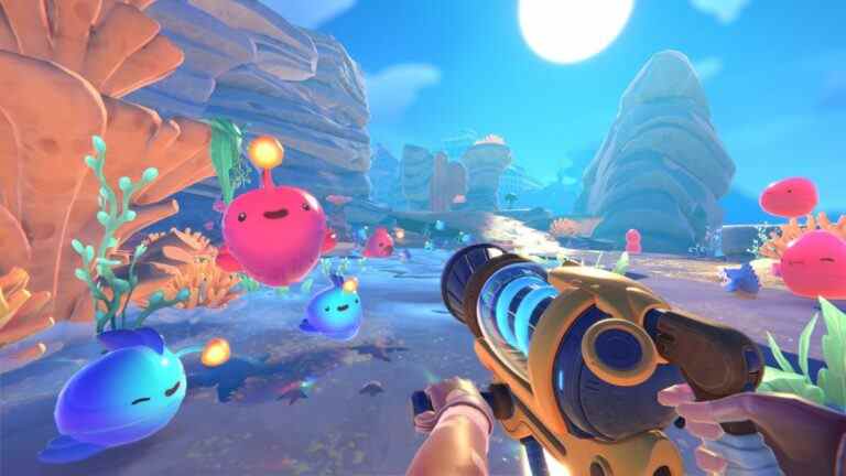 Blobs bouncing around in a colorful world while player points a vacuum tool at them