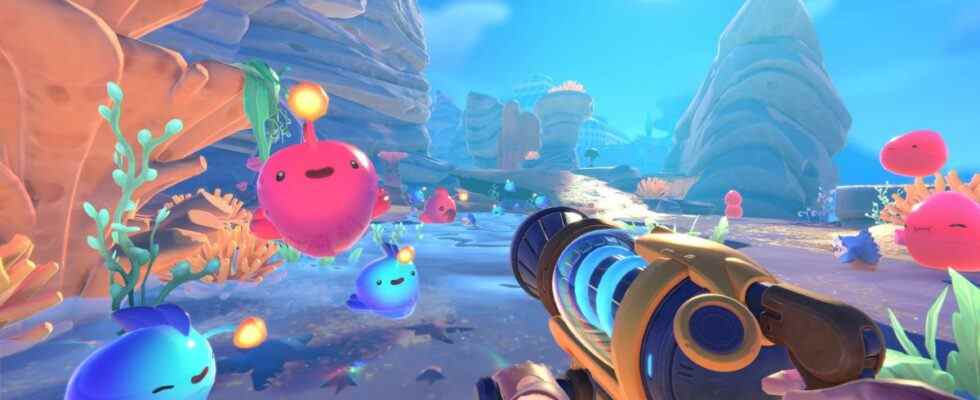 Blobs bouncing around in a colorful world while player points a vacuum tool at them