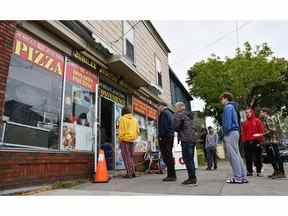 Les étudiants universitaires font la queue pour la nourriture due au Jubilee Junction Covenience Store alimenté par un générateur après le passage de l'ouragan Fiona, plus tard déclassé en tempête post-tropicale, dans le sud de Halifax, en Nouvelle-Écosse, le 24 septembre 2022.