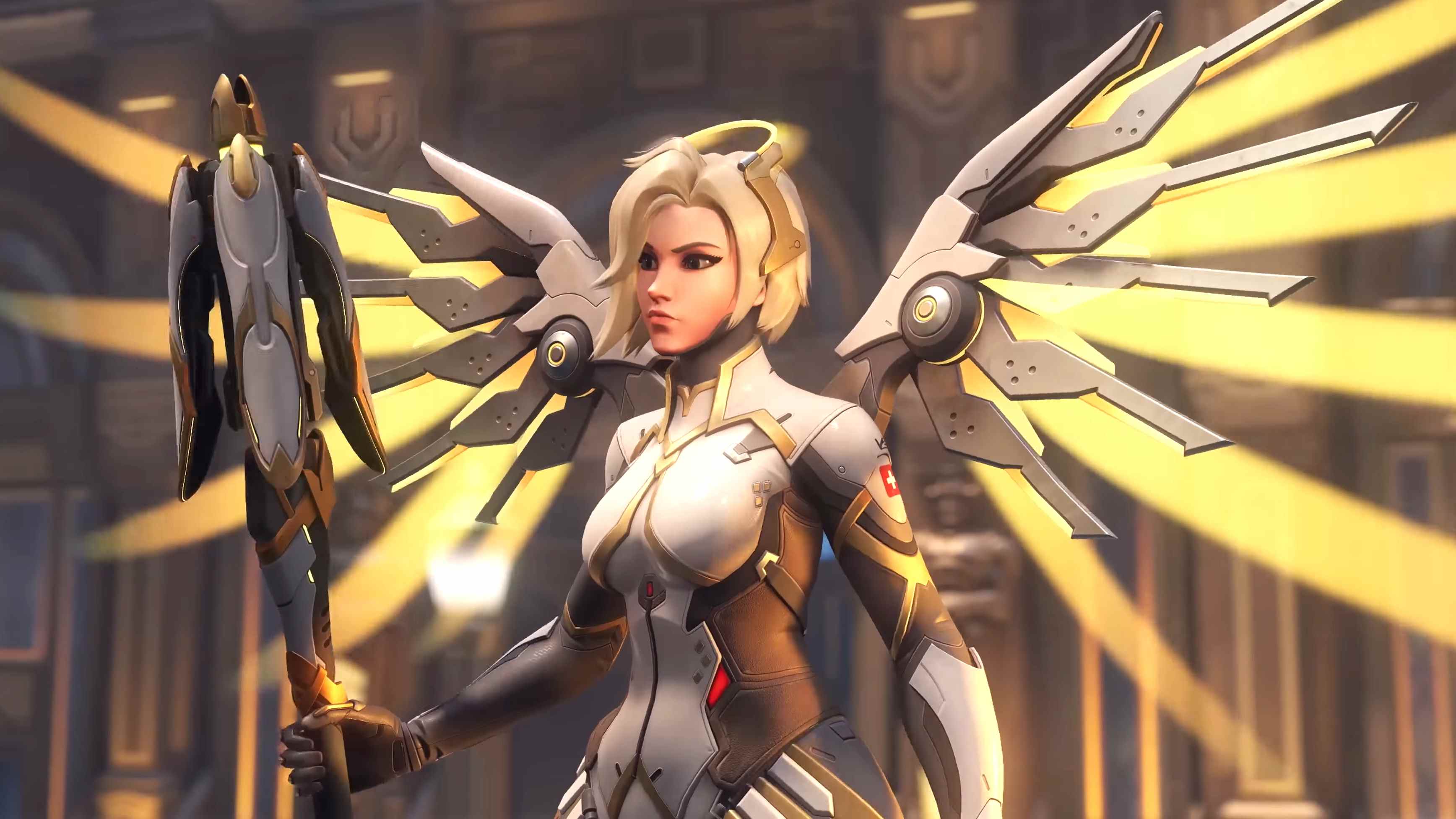 Mercy dans Overwatch 2 debout, tenant un bâton