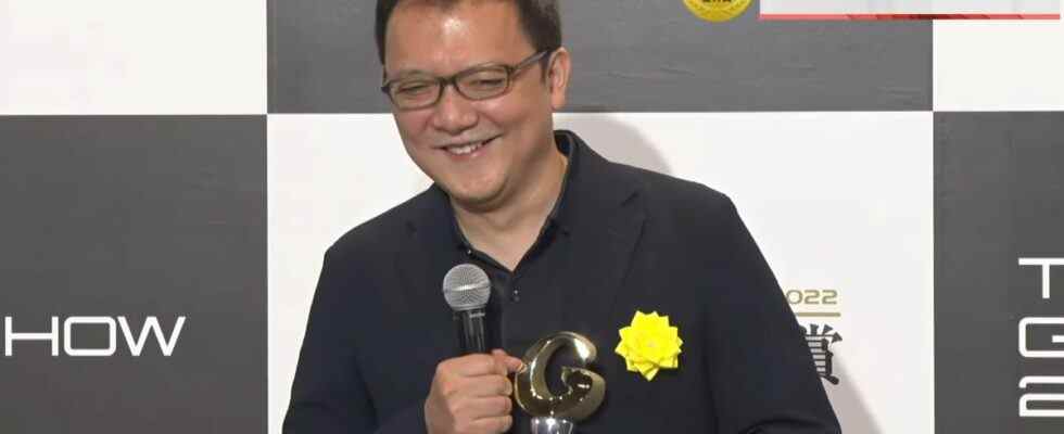 FromSoftware president Hidetaka Miyazaki smiles while holding Grand Award from the Tokyo Game Show