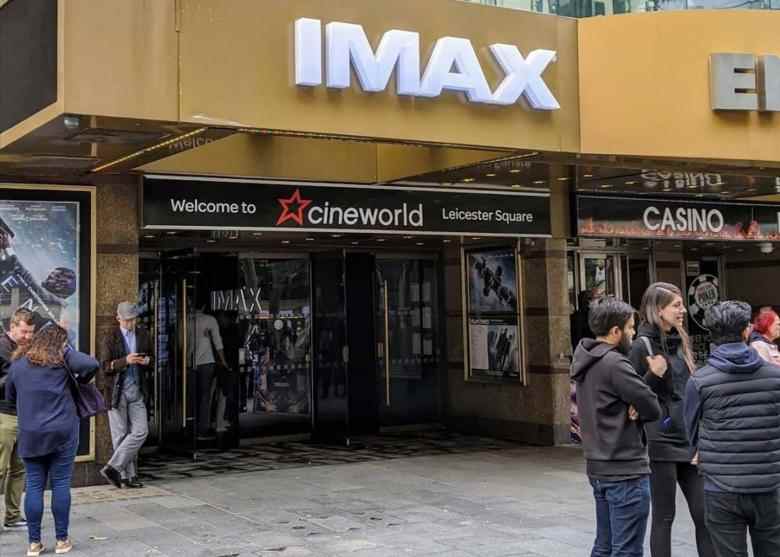 LONDON, ENGLAND - OCTOBER 05: People stand in front of a Cineworld IMAX cinema amid the coronavirus outbreak on October 5, 2020 in London, England. (Photo by Gao Tianyin/China News Service via Getty Images)