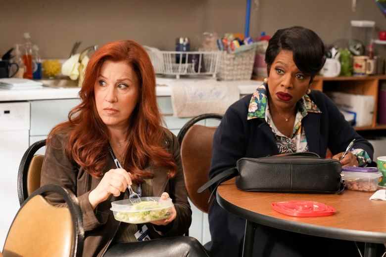 Two female teachers eat lunch at a staff room table, with a counter and sink behind them; still from "Abbott Elementary."