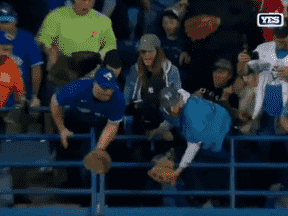 Deux fans des Blue Jays avec des gants n'arrivent pas à attraper le 61e coup de circuit frappé par Aaron Judge au Rogers Centre.