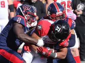 Micah Awe (2) des Alouettes de Montréal et Wesley Sutton (37) des Alouettes de Montréal ont battu Jackson Bennett (22) du Rouge et Noir d'Ottawa lors de la deuxième mi-temps de la LCF à Montréal le lundi 10 octobre 2022.