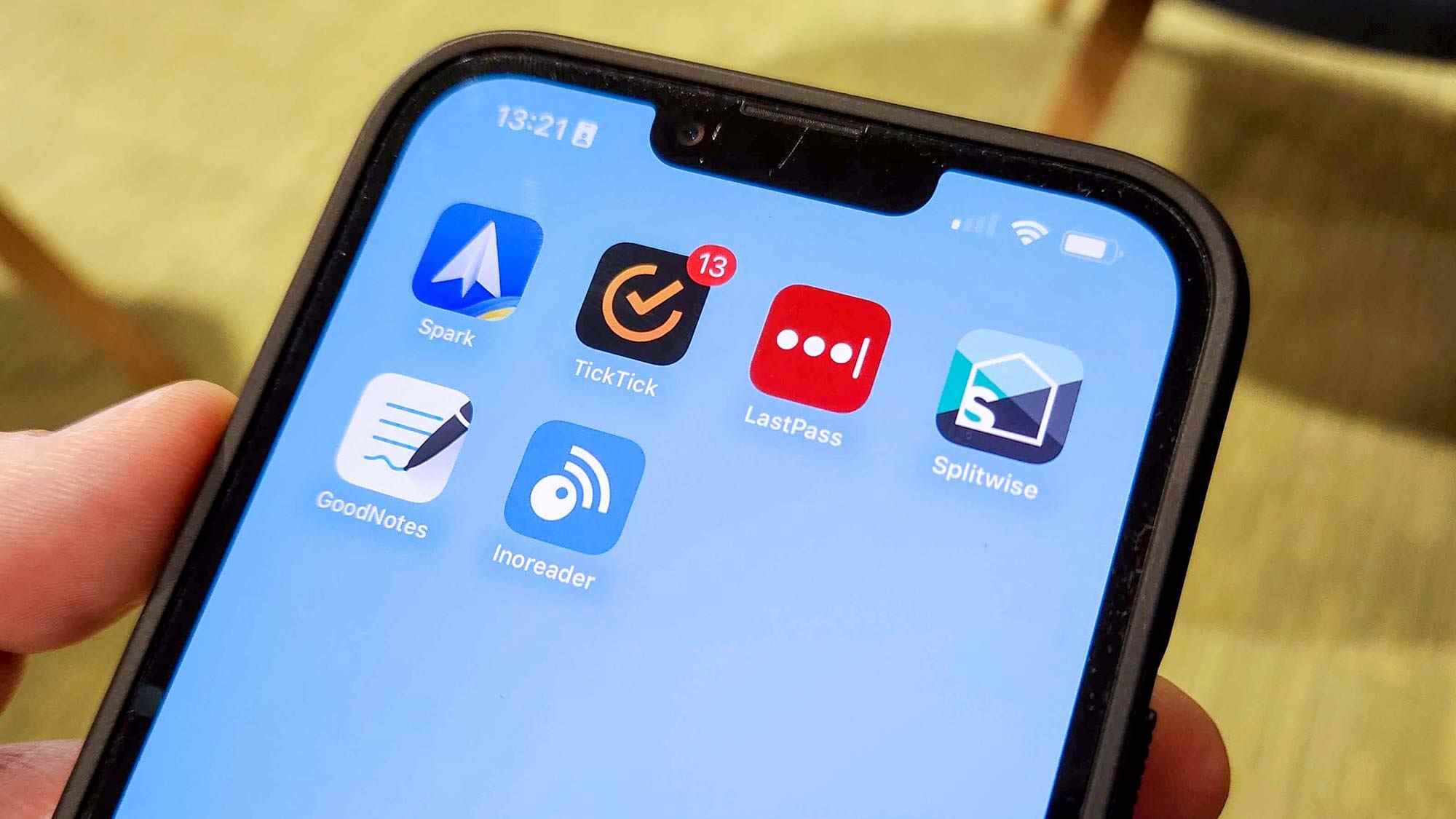 Un iPhone 13 Pro Max avec un écran d'accueil affichant Spark, TickTick, Lastpass, Splitwise, Goodnotes 5 et Inoreader