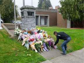 Un homme dépose des fleurs pour le const.  Shaelyn Yang au détachement de la GRC de Burnaby, en Colombie-Britannique, le jeudi 20 octobre 2022. Const.  Yang a été tué dans l'exercice de ses fonctions le 18 octobre à Broadview Park alors qu'il aidait un agent municipal à contrôler un sans-abri vivant dans le parc. (Photo de Jason Payne / PNG)