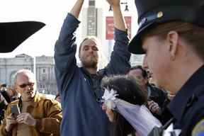 David DePape, au centre, enregistre Gypsy Taub emmenée par la police après son mariage nu devant l'hôtel de ville le 19 décembre 2013 à San Francisco.