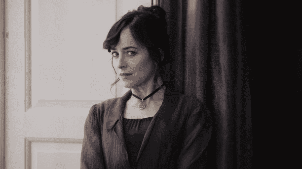 Dakota Johnson is Anne Elliot by a window in Persuasion.