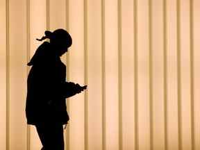 Une femme marche à l'intérieur du World Trade Center tout en utilisant un téléphone portable à New York.