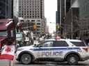 Un véhicule de la Police d'Ottawa bloque la rue Kent devant des camions stationnés pendant la 