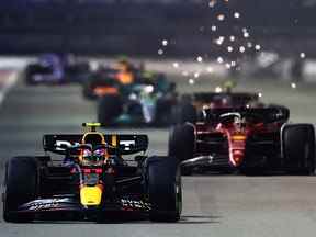 Sergio Perez, au volant de la (11) Oracle Red Bull Racing RB18, mène Charles Leclerc de Monaco lors du Grand Prix de Singapour au Marina Bay Street Circuit le 2 octobre 2022 à Singapour.