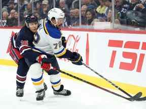 Le défenseur des Blues de St. Louis Justin Faulk (72 ans) affronte l'attaquant des Jets de Winnipeg Morgan Barron (36 ans) pour la rondelle au cours de la deuxième période au Canada Life Centre le 24 octobre 2022. Terrence Lee-USA TODAY Sports