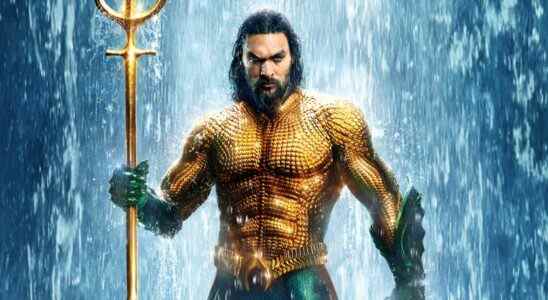 Aquaman in orange and green costume holding trident