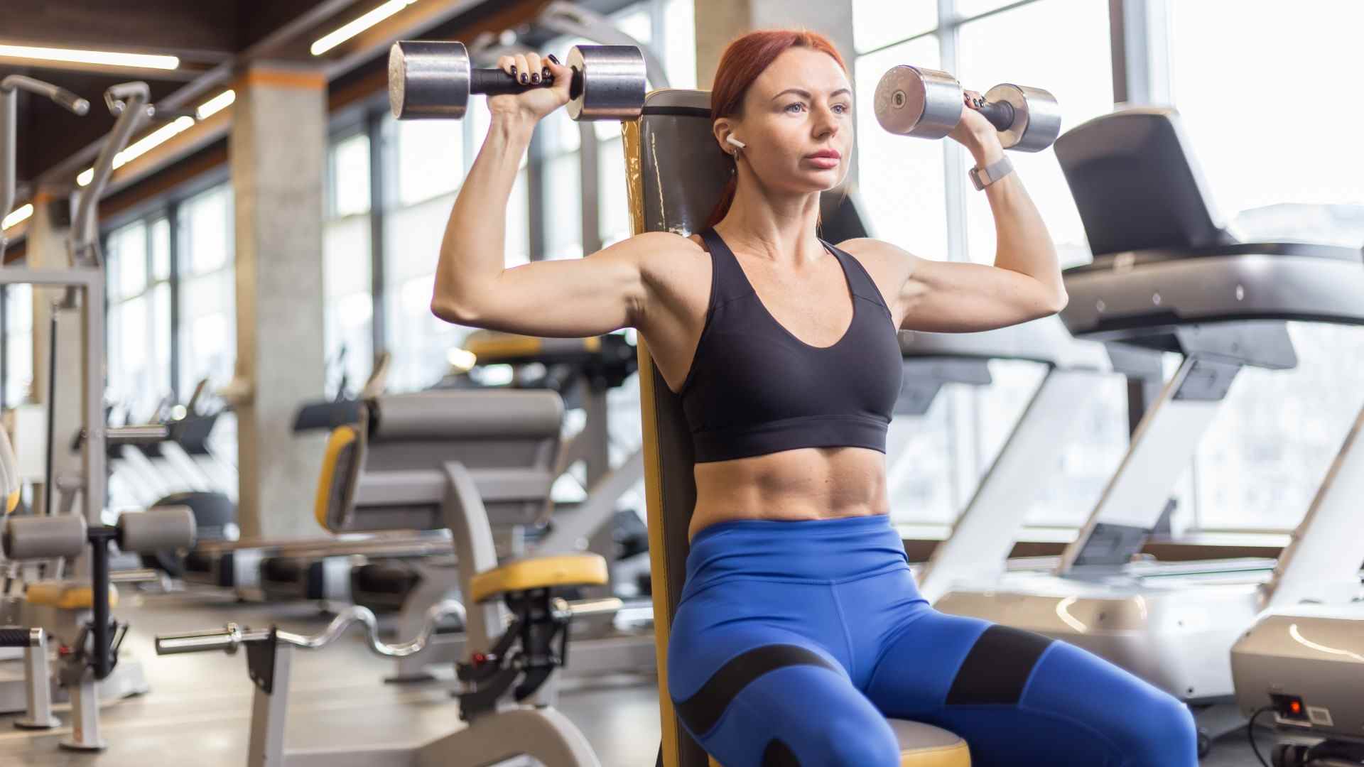 Femme faisant une presse Arnold assise