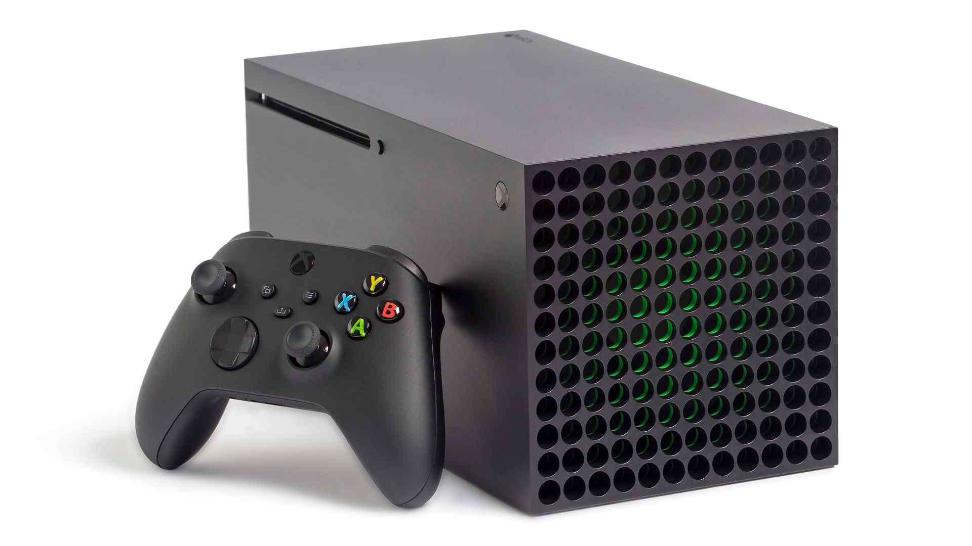 Xbox Series X allongée sur le côté avec une manette appuyée contre elle