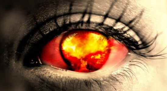 A nuclear explosion reflected in an eye.