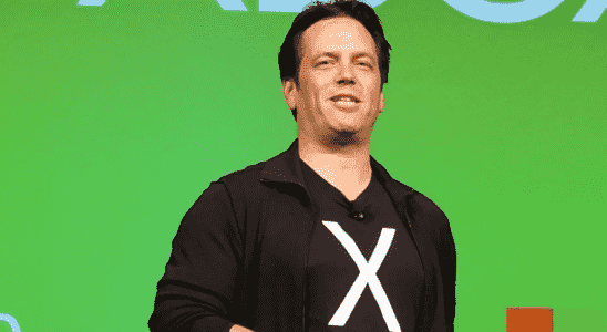 Phil Spencer giving a talk on stage, wearing a t-shirt with an