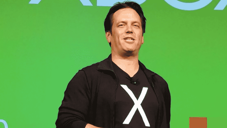 Phil Spencer giving a talk on stage, wearing a t-shirt with an 