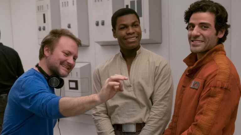 Rian Johnson directing John Boyega and Oscar Isaac on set with a laugh in Star Wars: The Last Jedi.