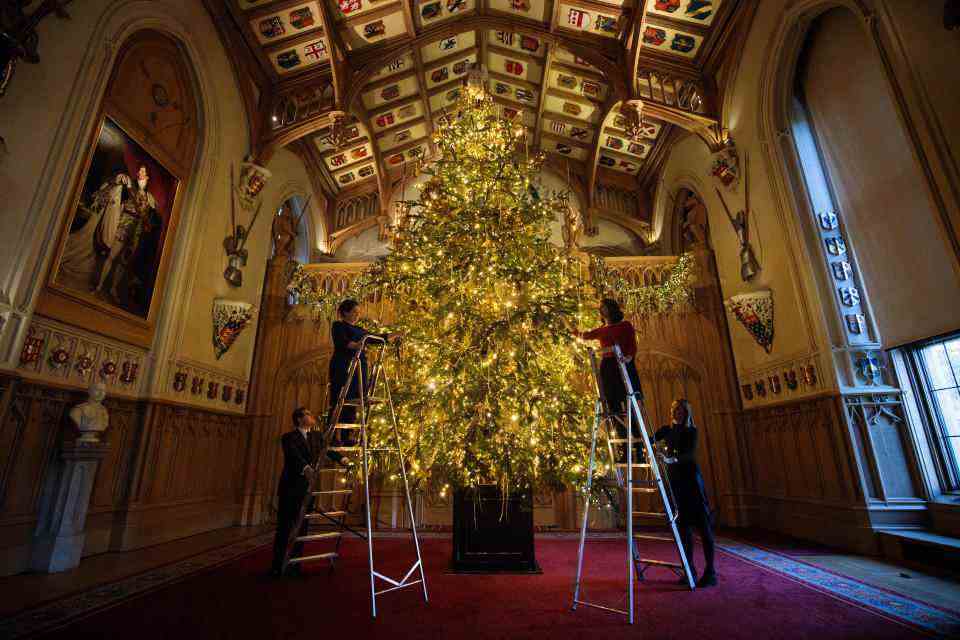 WINDSOR, ANGLETERRE - 23 NOVEMBRE : Les employés posent avec un sapin Nordmann de 20 pieds du Windsor Great Park à St George's Hall qui a été décoré pour la période de Noël le 23 novembre 2017 au château de Windsor, en Angleterre.  Les appartements d'État du château de Windsor sont utilisés par les membres de la famille royale pour l'hébergement et les événements.  La reine Elizabeth II réside au château de Windsor la plupart des week-ends et pendant la période de Pâques et c'est le plus ancien et le plus grand château habité du monde.  (Photo de Jack Taylor/Getty Images)