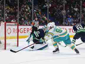 Alexander Barabanov (94 ans) des Sharks a raté le filet lors d'une tentative de tir contre le gardien des Canucks de Vancouver Spencer Martin (30 ans) lors de la deuxième période à Vancouver mardi soir