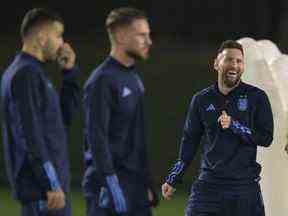 L'attaquant argentin Lionel Messi (R) rit lors d'une séance d'entraînement à l'Université du Qatar à Doha le 12 décembre 2022, à la veille du match de football de demi-finale de la Coupe du monde Qatar 2022 entre l'Argentine et la Croatie.