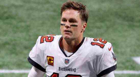 Tom Brady walking on the field at a game against the Atlanta Falcons.