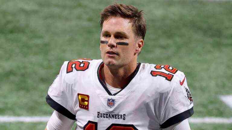 Tom Brady walking on the field at a game against the Atlanta Falcons.