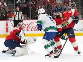 Le gardien de but des Panthers de la Floride Sergei Bobrovsky (72) effectue un arrêt derrière l'ailier droit des Canucks de Vancouver Brock Boeser (6) et le défenseur Radko Gudas (7) au cours de la première période au FLA Live Arena le 14 janvier 2023.