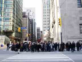 Piétons dans le quartier financier de Toronto.  Malgré nos nombreux avantages, la croissance économique du Canada a été moyenne.