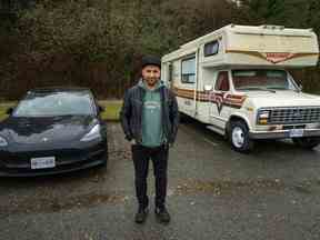 Lucas Philips est photographié à l'extérieur de son camping-car et à côté de sa Tesla dans un parking où il vivait à Spanish Banks, à Vancouver, en Colombie-Britannique, le jeudi 8 décembre 2022. Philips fait partie de la communauté des campeurs de Metro Vancouver, certains vivant sur roues comme stratégie économique, certaines comme choix de vie et d'autres comme dernier recours.