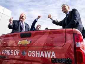 Le premier ministre de l'Ontario, Doug Ford, à gauche, et le ministre fédéral de l'Innovation, des Sciences et de l'Industrie, François-Philippe Champagne, à droite, sont assis à l'arrière d'une camionnette dans une usine de General Motors à Oshawa, en Ontario, le 4 avril 2022.