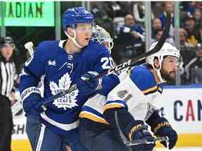 L'attaquant des Maple Leafs de Toronto Dryden Hunt lutte pour une place avec le défenseur des St. Louis Blues Robert Bortuzzo en première période à la Scotiabank Arena.