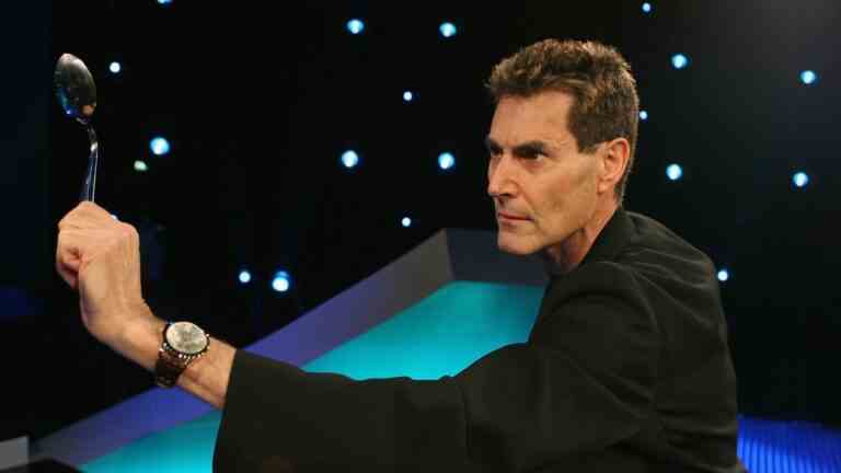 Uri Geller bending a spoon.