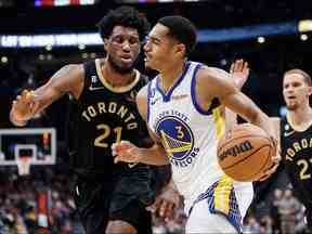 Jordan Poole des Golden State Warriors se dirige vers le filet contre Thaddeus Young des Raptors de Toronto lors de la première moitié de leur match NBA à la Scotiabank Arena le 18 décembre 2022 à Toronto, Canada.  Photo de Cole Burston/Getty Images