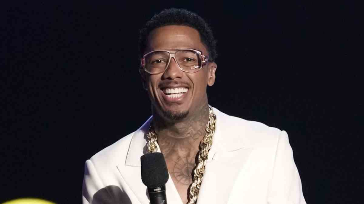 Nick Cannon wearing glasses and smiling on The Masked Singer