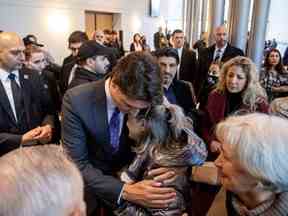 Le premier ministre Justin Trudeau embrasse Tourane Shamsolahi, le parent des victimes, lors d'un événement marquant le troisième anniversaire de la destruction du vol PS752 d'Ukraine International Airlines, qui a été abattu près de Téhéran par les gardiens de la révolution iraniens, à Toronto, le dimanche 8 janvier. , 2023.