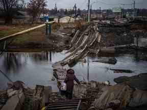 Une femme traverse un pont détruit à Bakhmut, dans la région de Donetsk, le 6 janvier.