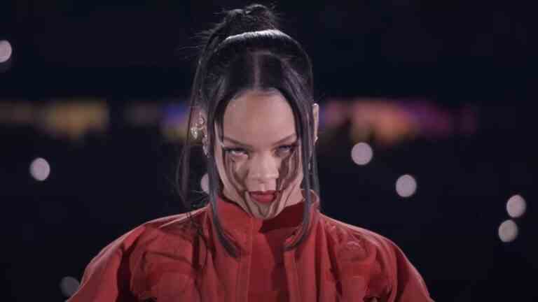 Rihanna looking into the camera at the start of her Super Bowl halftime show.