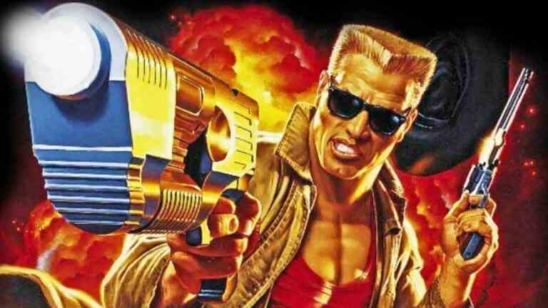 Duke Nukem with arm outstretched, pistol in hand, aiming at the screen