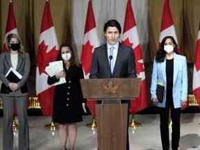 Le premier ministre Justin Trudeau est accompagné de la ministre des Affaires étrangères Melanie Joly, à gauche, de la vice-première ministre et ministre des Finances Chrystia Freeland, et de la ministre de la Défense nationale Anita Anand, à droite, alors qu'il s'exprime lors d'un point de presse sur la situation en Ukraine, en Ottawa, 22 février 2022.