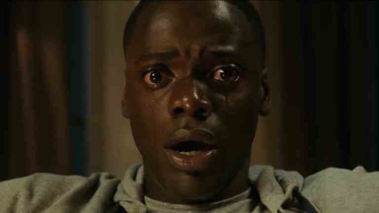 A close-up of Daniel Kaluuya shedding tears in a scene from Get Out.