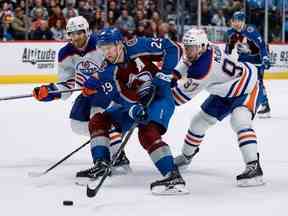 19 février 2023 ;  Denver, Colorado, États-Unis ;  Le centre de l'Avalanche du Colorado Nathan MacKinnon (29) contrôle la rondelle sous la pression du centre des Oilers d'Edmonton Connor McDavid (97) et du défenseur Evan Bouchard (2) en prolongation au Ball Arena.  Crédit obligatoire : Isaiah J. Downing - USA TODAY Sports