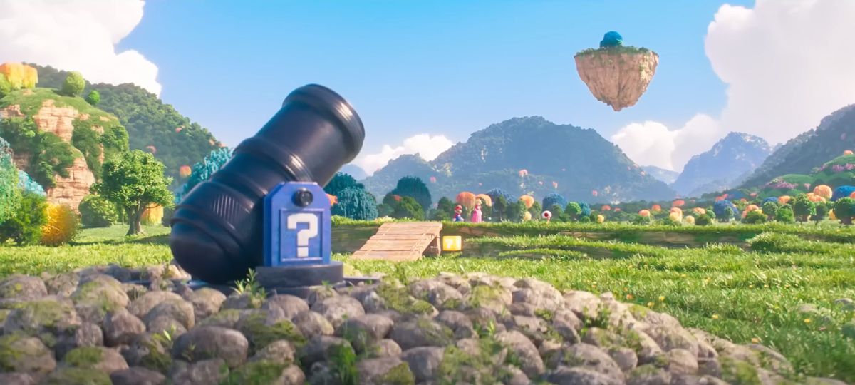 Une photo de paysage de la version du film Bob-omb Battlefield de The Super Mario Bros., avec un canon au premier plan et Mario, Peach et Toad à l'arrière-plan