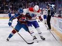 L'ailier gauche de l'Avalanche du Colorado Artturi Lehkonen (62) et le centre des Canadiens de Montréal Kirby Dach (77) se battent pour la rondelle en première période à Denver le 21 décembre 2022.