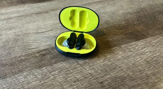 Logitech G Fits earbuds in a black and yellow case on a wooden table