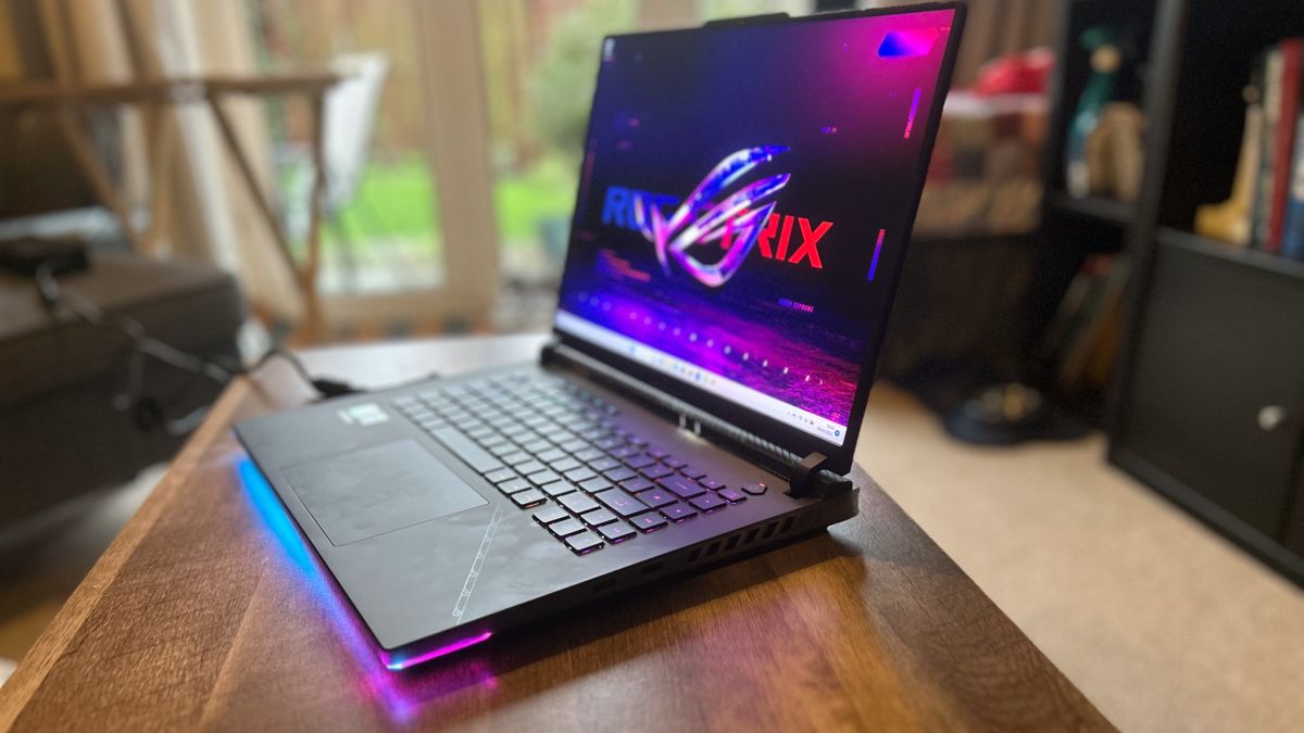 Asus ROG Strix Scar 16 gaming laptop open on a wooden table