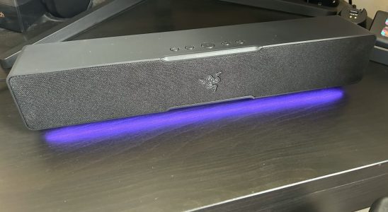 Razer Leviathan V2 X soundbar on a desk with RGB lighting switched on