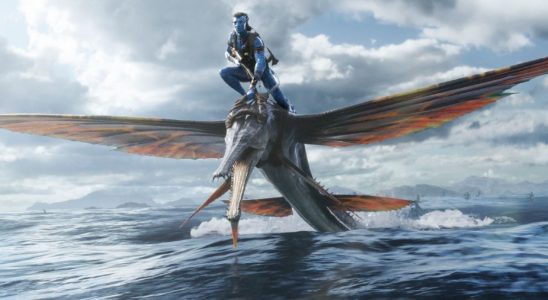 Jake rides a winged creature over the ocean in Avatar: The Way of Water.